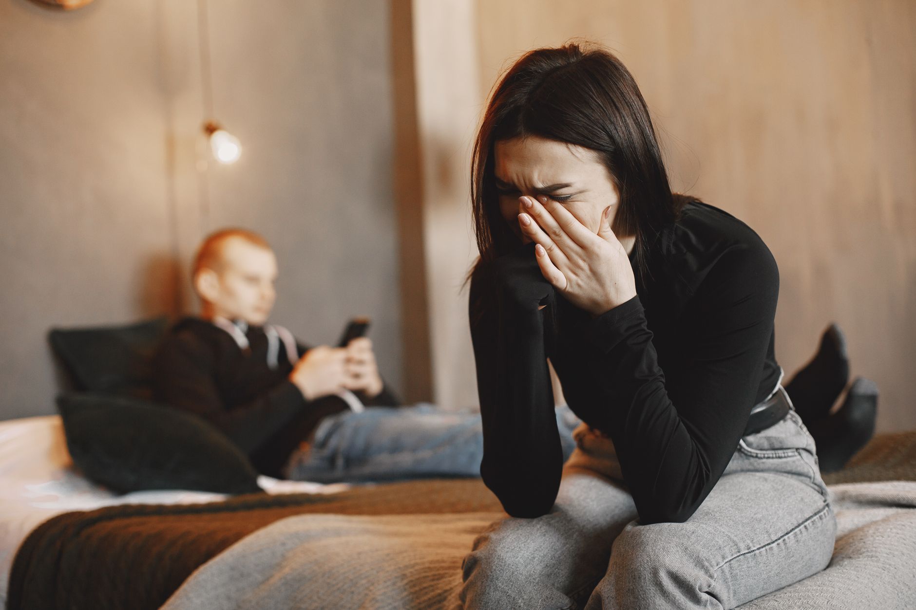 photo of a woman in a black top crying
